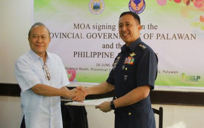 <p>NEW MILITARY BASE IN PALAWAN SOON. Governor Jose Alvarez (left) and Philippine Air Force commanding general Lt. Gen. Galileo Gerard Kintanar Jr. shake their hands following their signing of a memorandum of agreement for the establishment of a military air base in Balabac town, southern Palawan. <em>(Photo courtesy of PIO)</em></p>